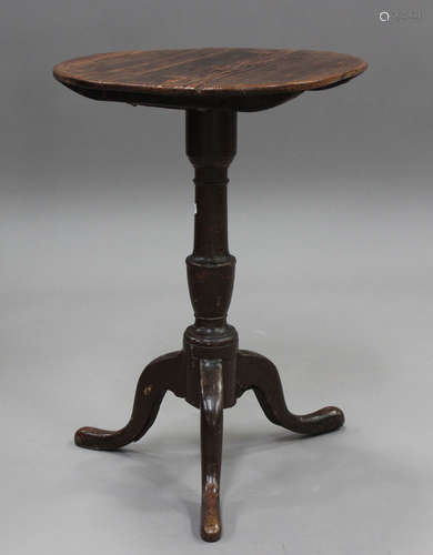 A 19th century provincial pine wine table, the circular top ...