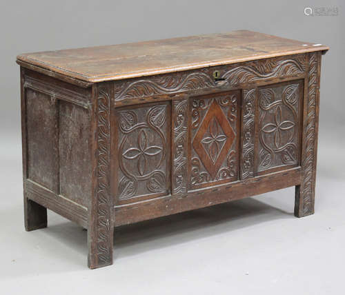 A late 17th/early 18th century oak coffer, the hinged lid ab...