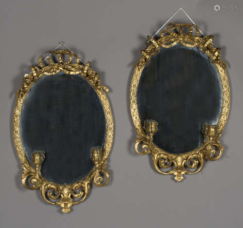 A pair of late Victorian gilt painted composition oval giran...
