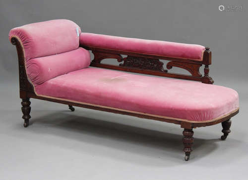 A late Victorian walnut framed chaise longue, upholstered in...