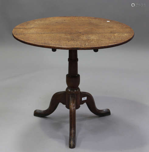 An early Victorian oak tip-top wine table, raised on tripod ...