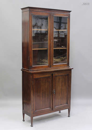 A George V mahogany bookcase cabinet, the moulded pediment a...