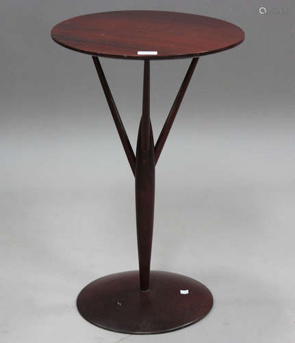 A mid-20th century hardwood wine table, raised on angular su...