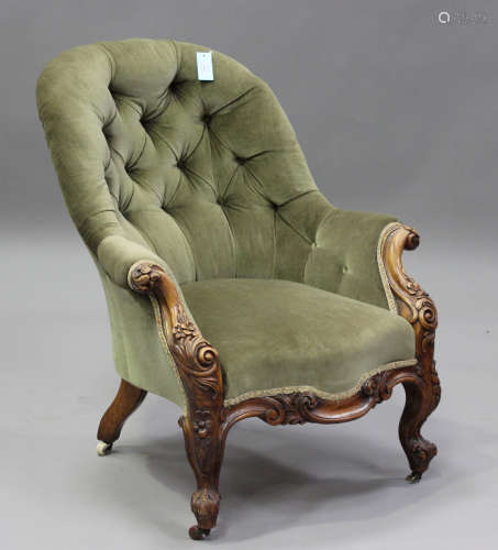 A mid-Victorian walnut tub back armchair, upholstered in but...