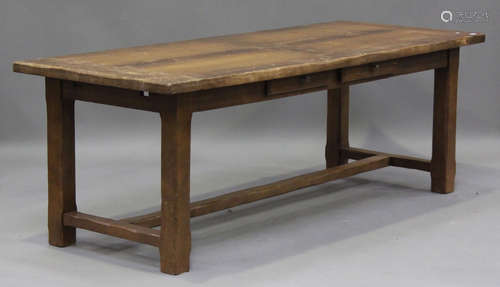 A 20th century oak refectory table, raised on chamfered bloc...