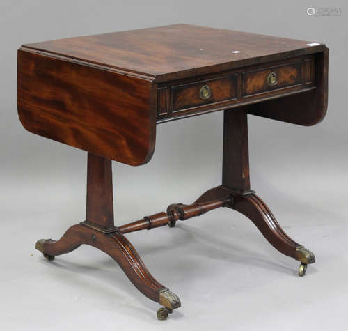 A George V mahogany sofa table, fitted with fall-flaps and f...