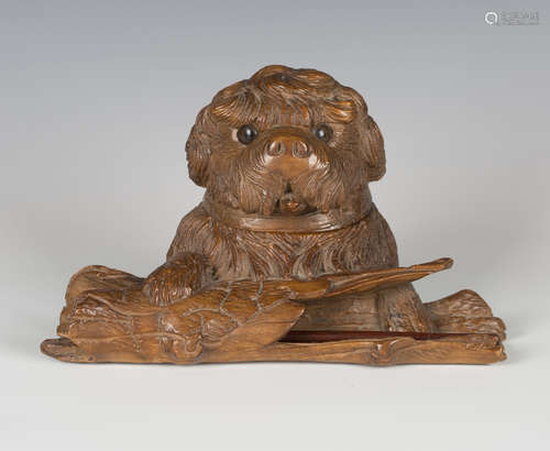 A late 19th/early 20th century Swiss Black Forest carved sof...