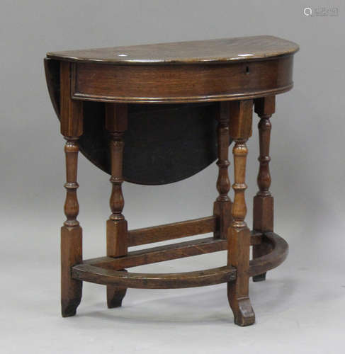 An 18th century and later oak demi-lune credence table, the ...