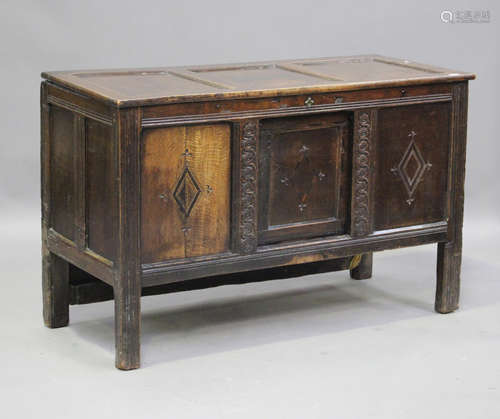 An 18th century oak panelled mule chest, the hinged lid abov...