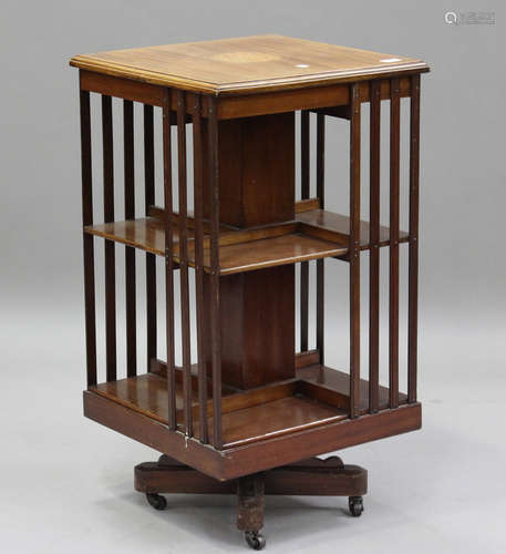 An Edwardian mahogany revolving bookcase with slatted sides,...