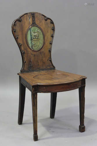 An 18th century mahogany hall chair, the shaped back painted...