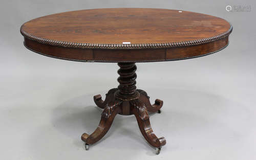 A mid-19th century French rosewood oval centre table, fitted...