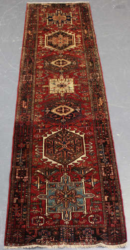 A Heriz runner, North-west Persia, mid-20th century, the red...