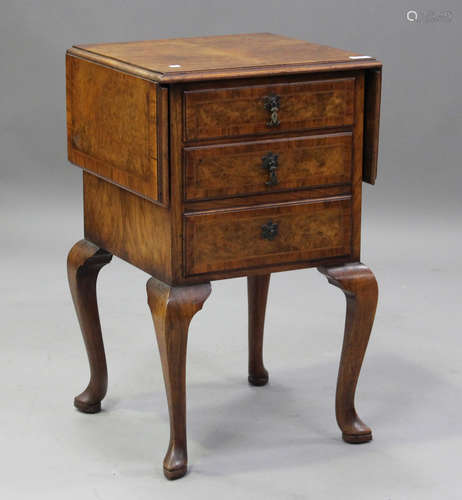 An early 20th century burr walnut drop-flap bedside cabinet,...