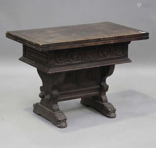 A 19th century French oak fold-over credence table with carv...