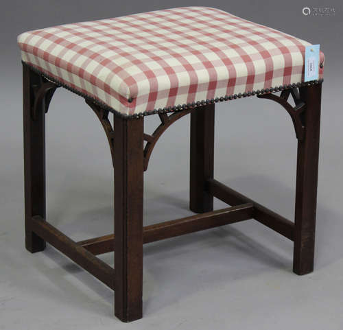 A George III mahogany stool, the overstuffed seat on chamfer...