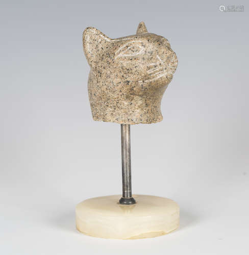 A carved granite fragmentary model of a cat's head, possibly...