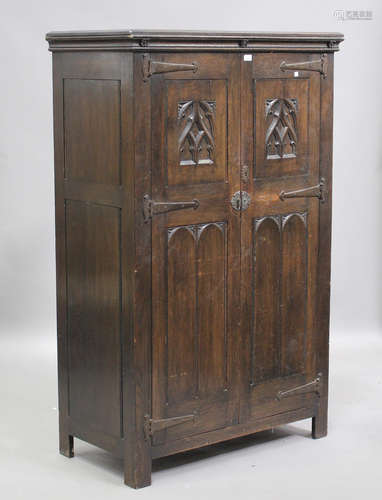 An early 20th century Gothic Revival oak two-door wardrobe w...