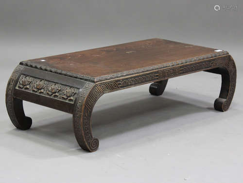 A 20th century Chinese hardwood low table with carved decora...