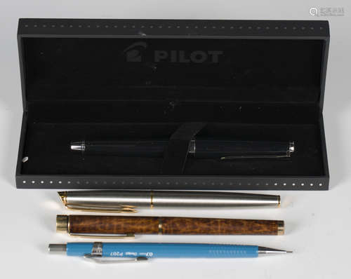 A group of writing implements, including a Pilot Japan black...