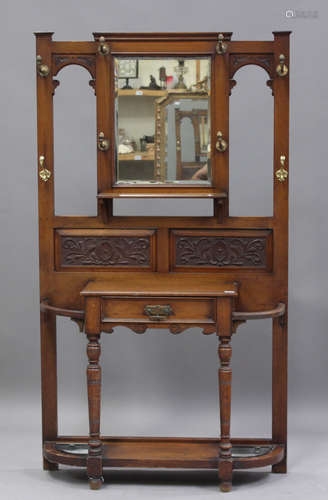 A late Victorian oak hallstand with carved foliate decoratio...