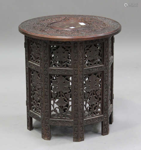 A 20th century Indian carved hardwood and brass inlaid foldi...