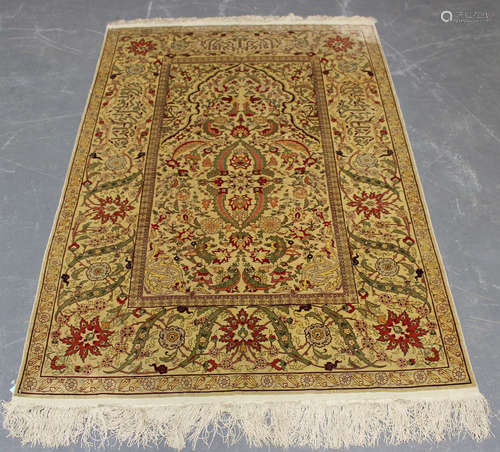 A Hereke silk prayer rug, Turkey, late 20th century, the ivo...