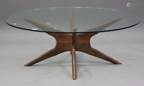 A mid-20th century teak and glass circular coffee table, hei...