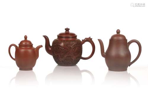 Three Yixing teapots Chinese comprising of a carved example ...