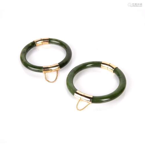 Two spinach jadeite bangles Chinese with yellow metal mounts...