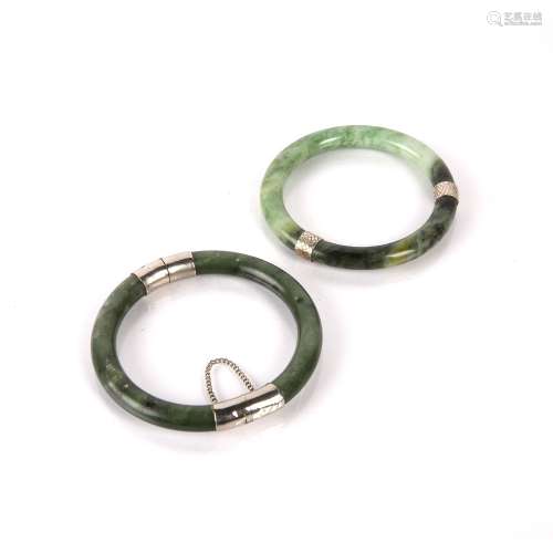 Two spinach jadeite bangles Chinese with white metal mounts,...