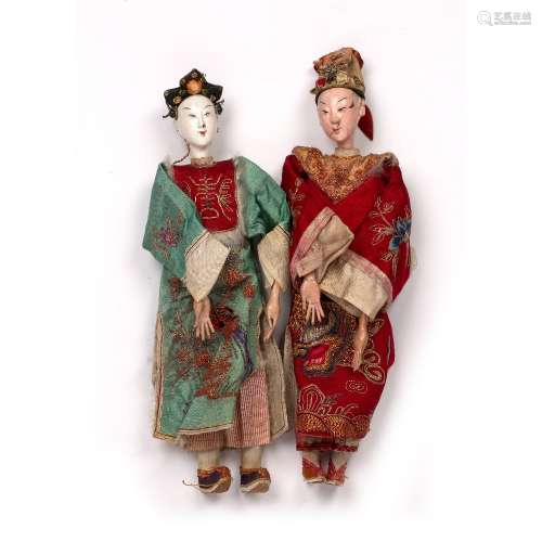 Two dolls Chinese with painted white faces, dressed in elabo...
