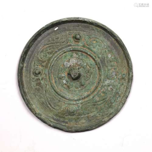Bronze mirror Han dynasty with scroll design and four bosses...