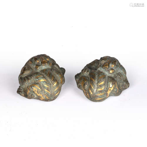 Pair of bronze 'tiger' mat weights Chinese, parcel gilded, b...