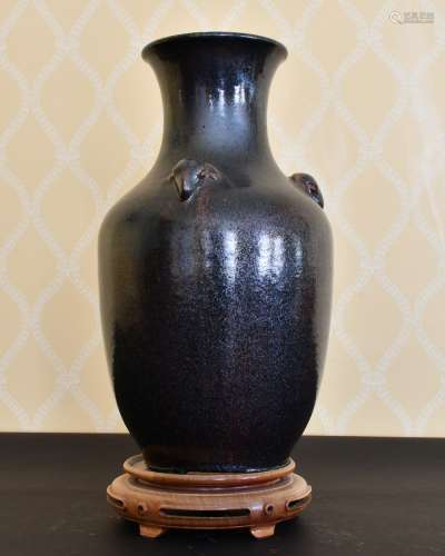 A CHINESE POTTERY VASE with rams mask handles. 15ins high, o...