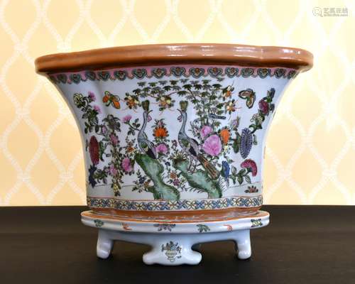 A CHINESE PORCELAIN OVAL FLORAL JARDINIERE AND STAND.