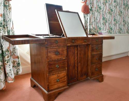 A GENTLEMAN'S MAHOGANY DRESSING TABLE with folding flaps, mi...