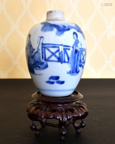 A KANG HSI BLUE AND WHITE VASE painted with figures and fenc...