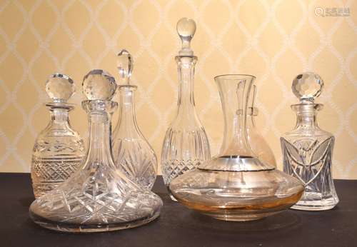 A CUT GLASS SHIPS DECANTER AND STOPPER AND SIX OTHER DECANTE...