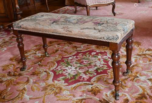 A LONG VICTORIAN PIANO STOOL with tapestry top, on turned le...