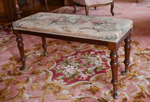 A LONG VICTORIAN PIANO STOOL with tapestry top, on turned le...