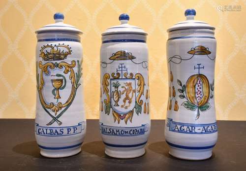 A SET OF THREE SPANISH POTTERY DRUG JARS AND COVERS.