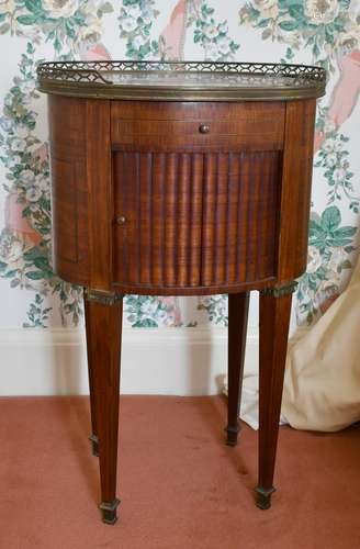 A FRENCH OVAL BEDSIDE TABLE with marble top, tambour front, ...