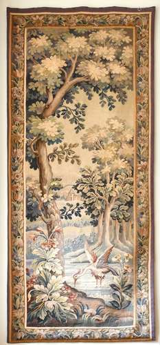 AN ANTIQUE BRUSSELS LONG TAPESTRY, a bird, trees and buildin...