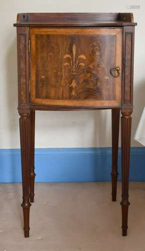 A MAHOGANY INLAID BOWFRONTED BEDSIDE TABLE on turned legs, 1...