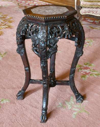 A CHINESE CARVED HARDWOOD PLANT STAND with octagonal top and...