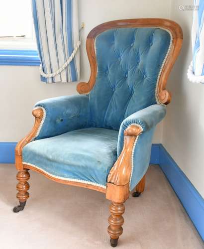 A BUTTONED BACK ARMCHAIR.