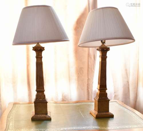 A PAIR OF ITALIAN GILTWOOD CANDLESTICKS with lamp shades.