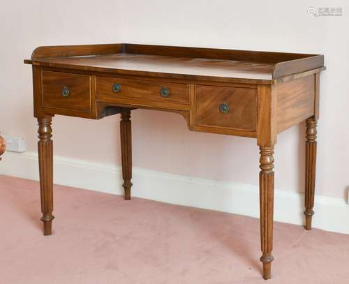 A WILLIAM IV MAHOGANY TABLE with three drawers, on fluted le...