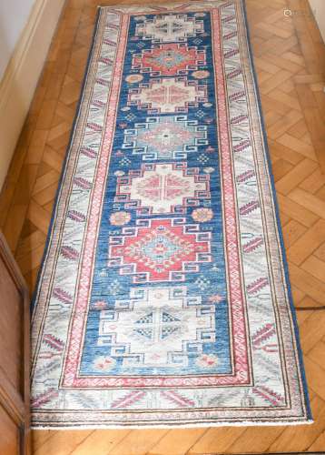 A SMALL PERSIAN RUNNER RUG with seven medallions. 8ft x 2ft ...